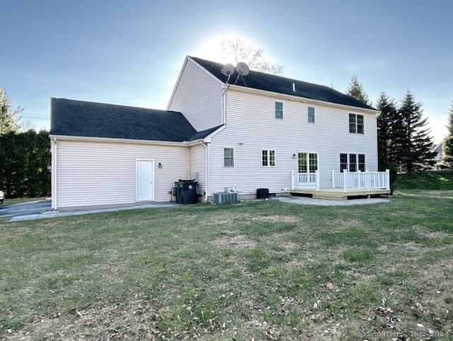 back of house with a lawn, cooling unit, and a wooden deck