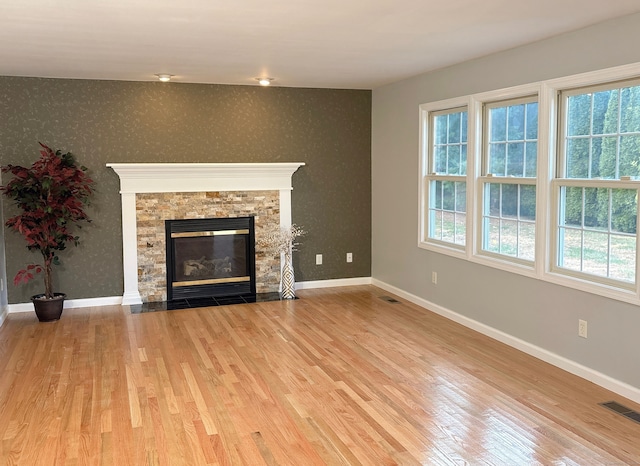 unfurnished living room featuring a fireplace and light wood-type flooring