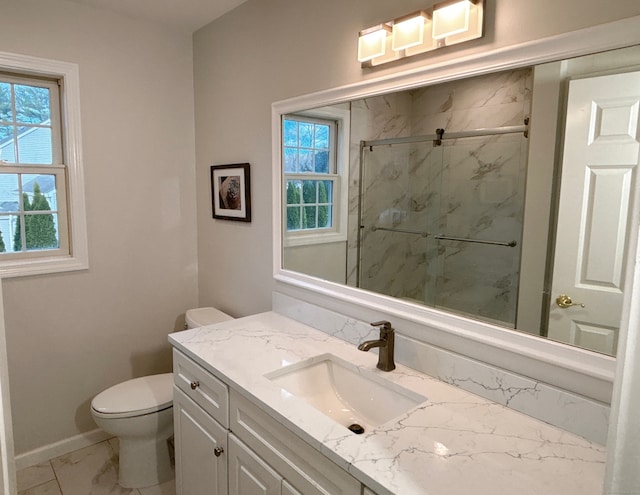 bathroom featuring vanity, toilet, and an enclosed shower