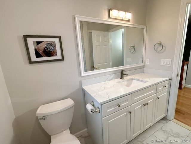 bathroom featuring hardwood / wood-style flooring, vanity, and toilet