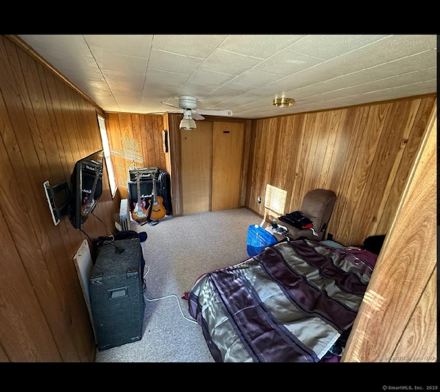 bedroom featuring carpet floors and wood walls