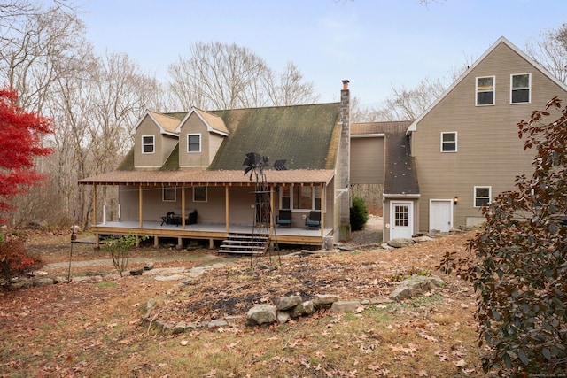 rear view of house featuring a deck