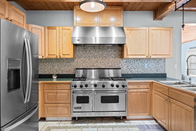 kitchen with wall chimney exhaust hood, sink, stainless steel appliances, and tasteful backsplash