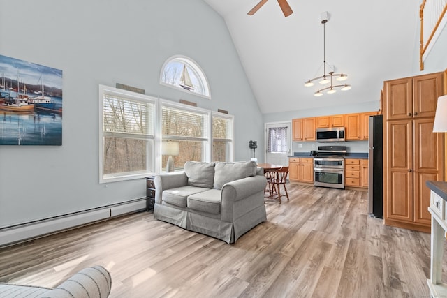 living room featuring ceiling fan with notable chandelier, light wood-type flooring, a baseboard radiator, and high vaulted ceiling