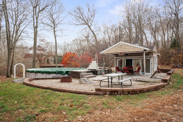 view of yard featuring a patio and a covered pool