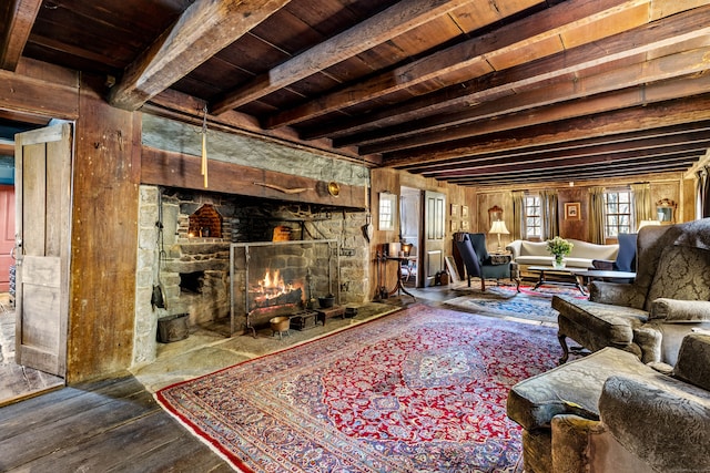 living room featuring wooden ceiling, wooden walls, hardwood / wood-style flooring, a fireplace, and beamed ceiling