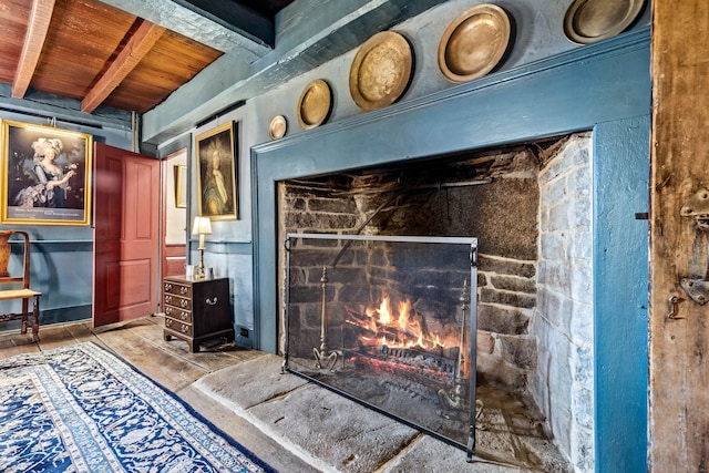 details featuring beamed ceiling, a fireplace, and wooden ceiling