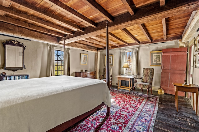 bedroom with beam ceiling, hardwood / wood-style flooring, and wooden ceiling