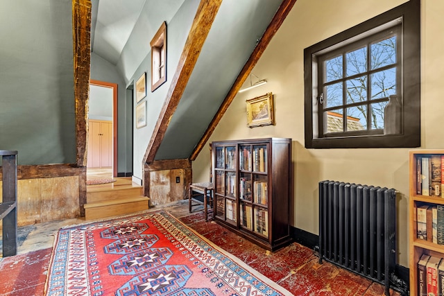 living area with radiator and lofted ceiling