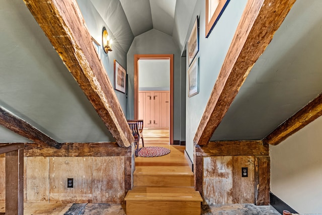 interior space with hardwood / wood-style flooring and lofted ceiling with beams