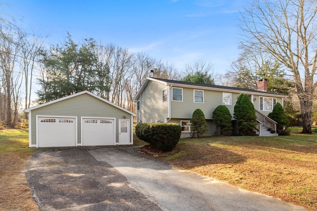 view of front of home with a front yard and a garage