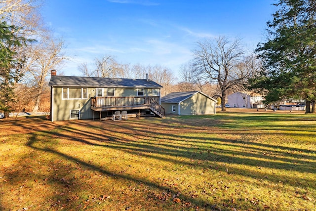 rear view of property with a lawn and a deck