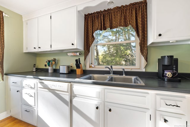 kitchen with white cabinets, sink, white dishwasher, and light hardwood / wood-style flooring