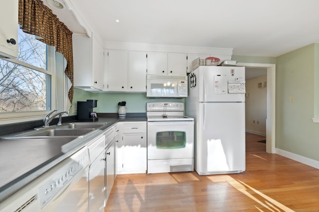 kitchen with white cabinets, white appliances, sink, and light hardwood / wood-style flooring