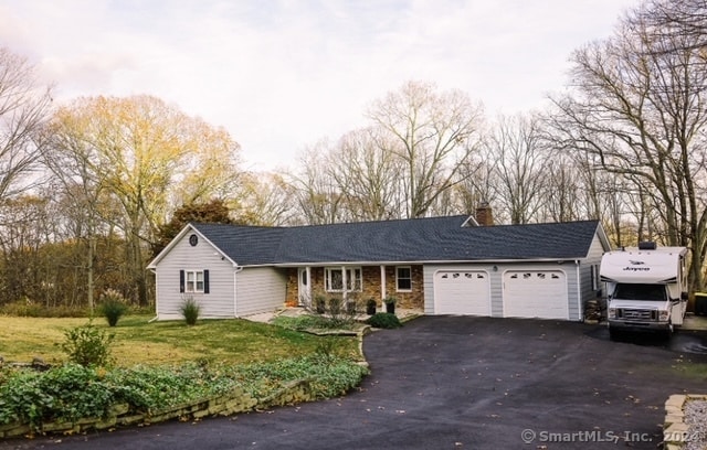 ranch-style home with a front yard and a garage