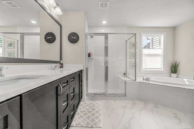 bathroom with vanity and independent shower and bath