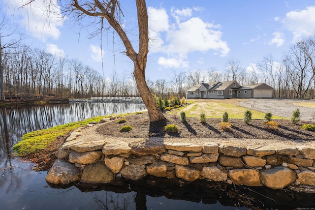 view of yard featuring a garage and a water view