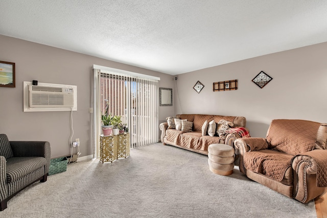 living room featuring an AC wall unit, light colored carpet, and a textured ceiling