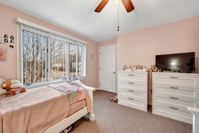 bedroom with ceiling fan and light carpet