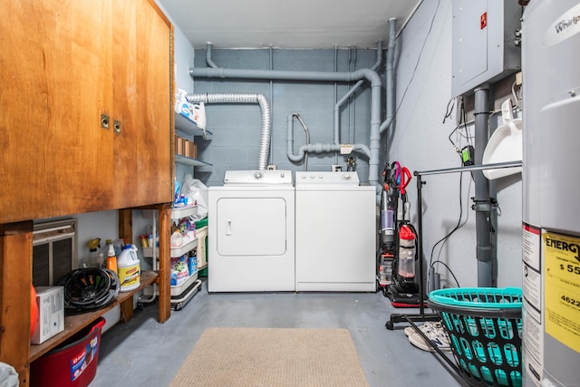 clothes washing area with washing machine and dryer and water heater