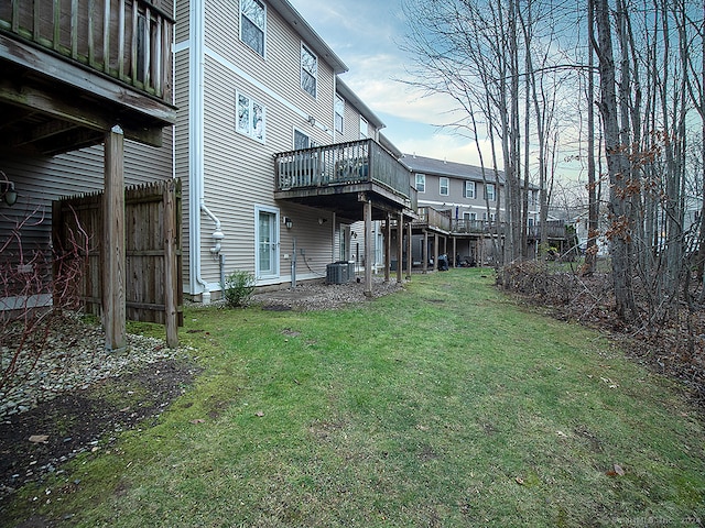 view of yard featuring central AC unit and a wooden deck