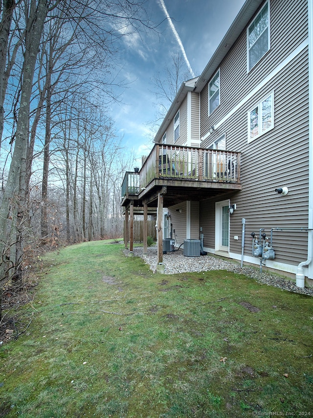 view of yard featuring a wooden deck and central AC unit