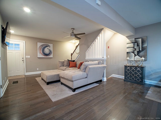 living room featuring dark hardwood / wood-style floors and ceiling fan