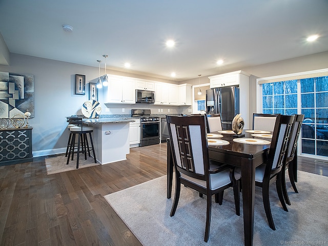 dining area with dark hardwood / wood-style flooring