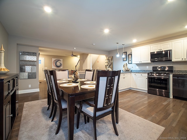 dining area featuring ceiling fan and dark hardwood / wood-style flooring