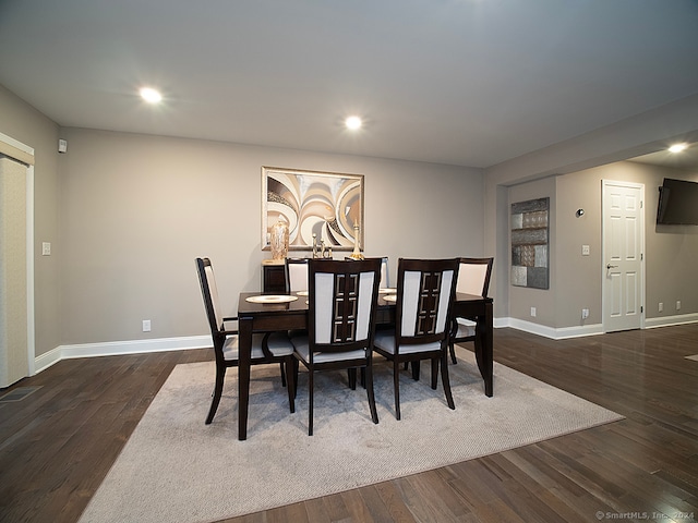 dining area with dark hardwood / wood-style floors