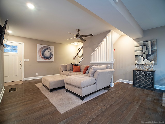 living room with ceiling fan and dark hardwood / wood-style flooring