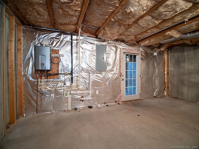 basement featuring electric panel and water heater