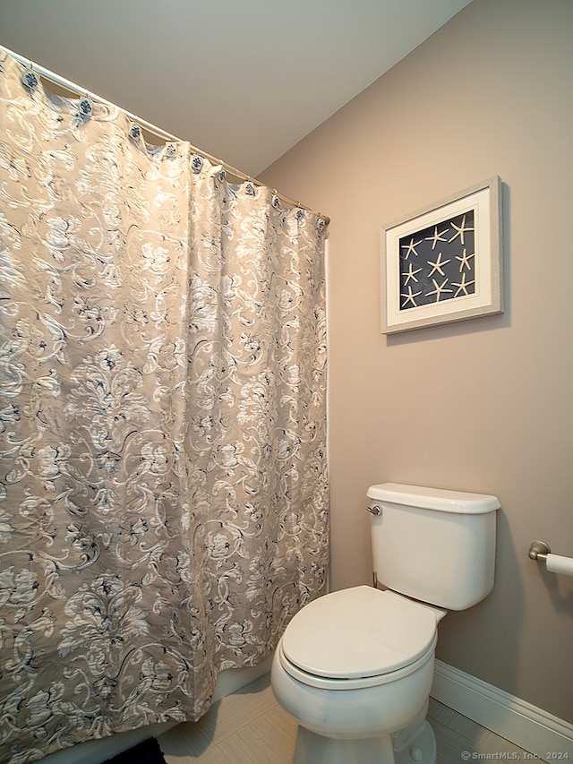 bathroom with tile patterned flooring and toilet