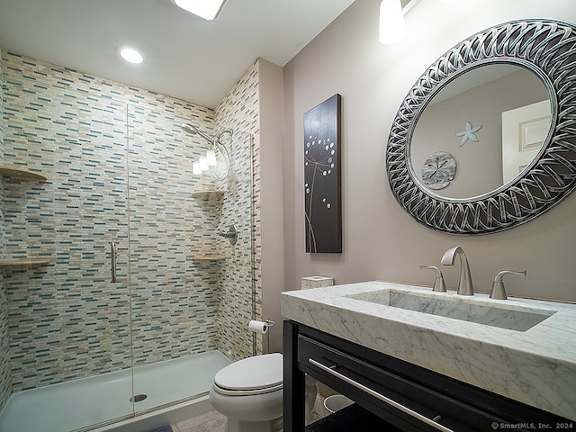 bathroom with vanity, toilet, and an enclosed shower