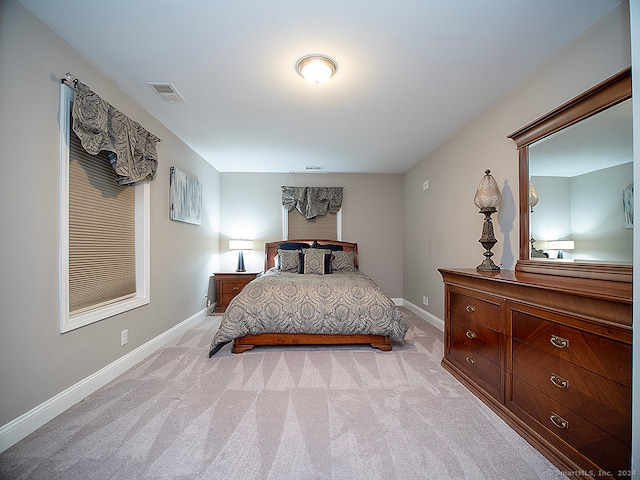 bedroom featuring light carpet