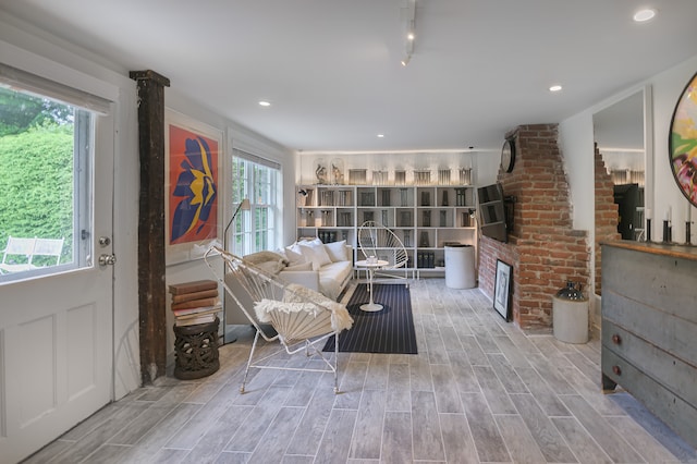 sitting room with a wealth of natural light and hardwood / wood-style flooring