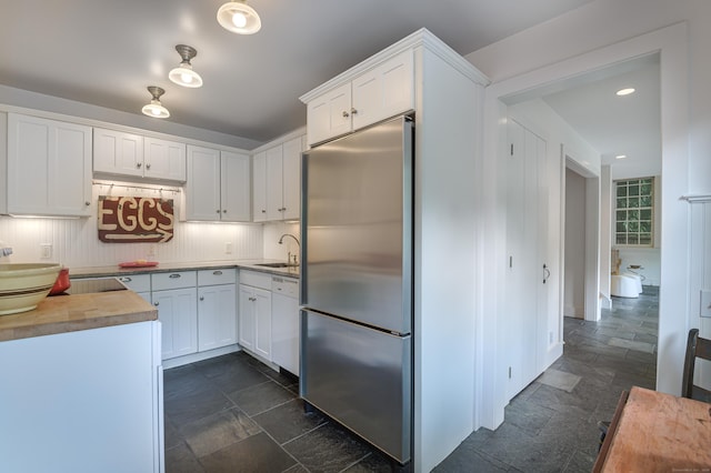 279 Black Rock Tpke, Redding, CT 06896 - kitchen featuring stainless steel refrigerator, stone tile floors, white cabinetry, butcher block counters, and recessed lighting