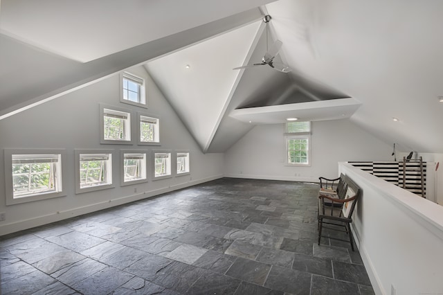 additional living space with ceiling fan, lofted ceiling, and a wealth of natural light