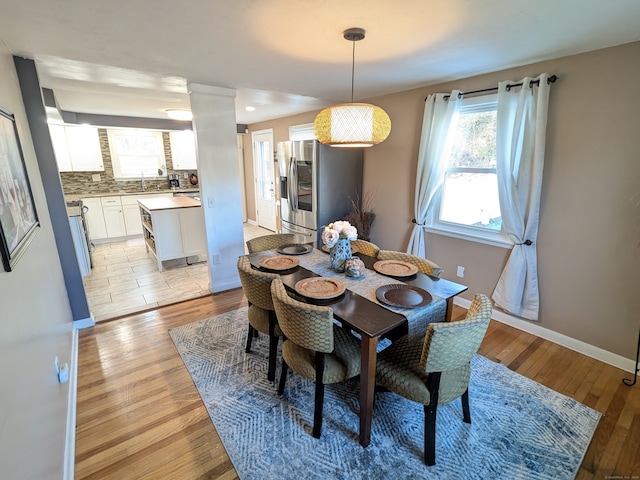 dining room featuring light wood-type flooring and sink