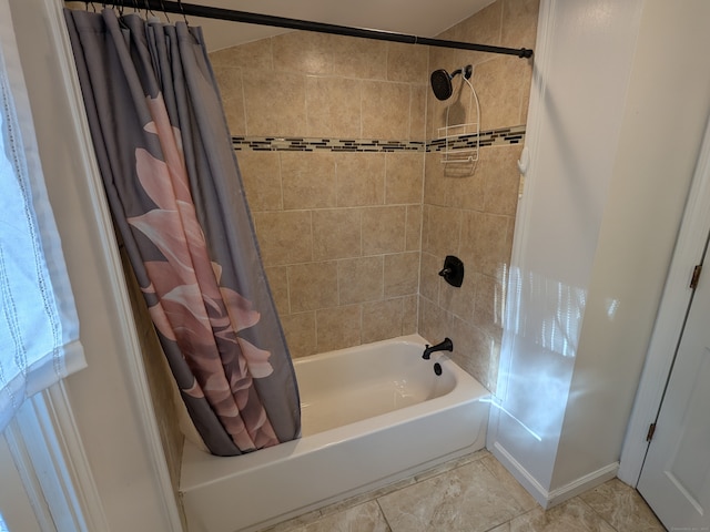 bathroom with shower / bath combination with curtain