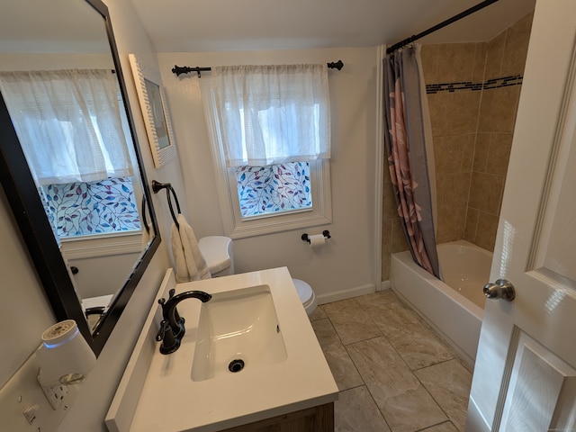 full bathroom with vanity, shower / bath combo, and toilet