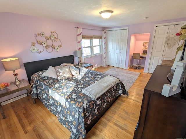 bedroom featuring multiple closets and hardwood / wood-style flooring