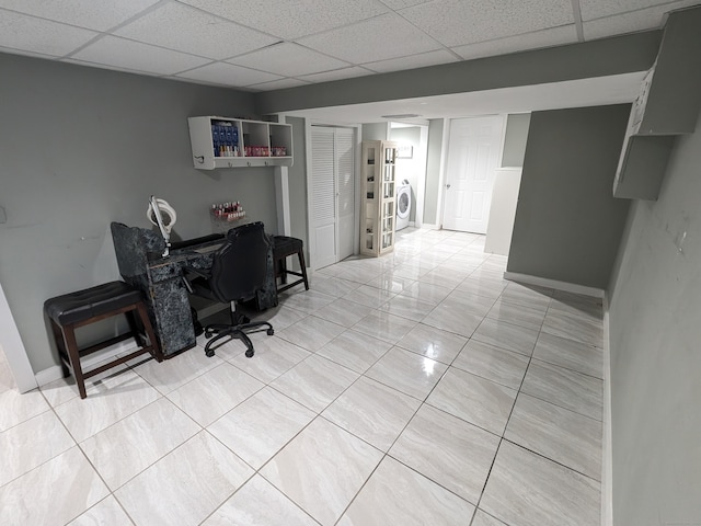 office featuring light tile patterned floors, a paneled ceiling, and washer / clothes dryer