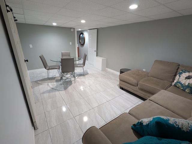 living room featuring a paneled ceiling