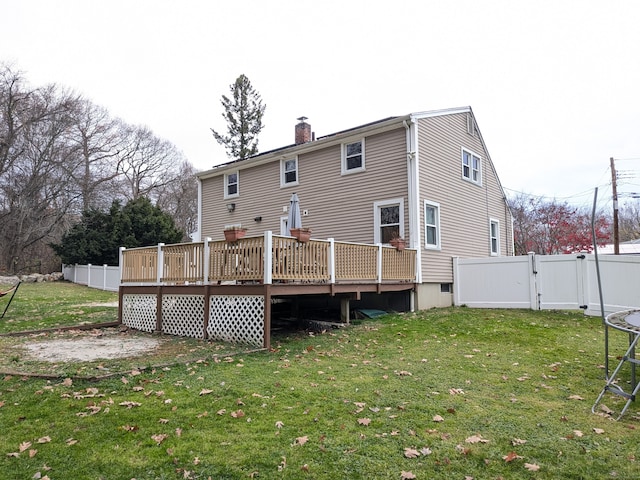 back of house with a yard and a deck