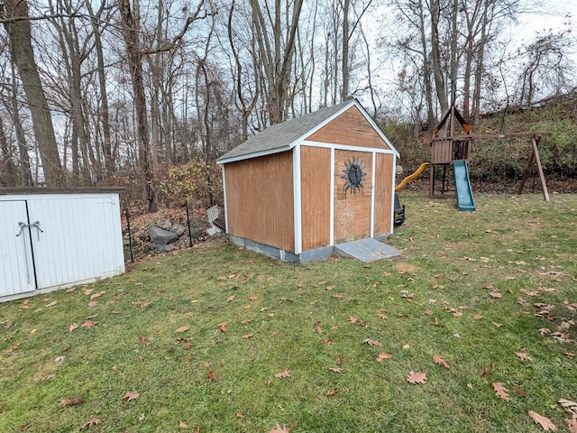 view of outbuilding with a yard and a playground