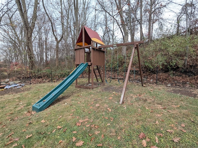 view of jungle gym featuring a lawn