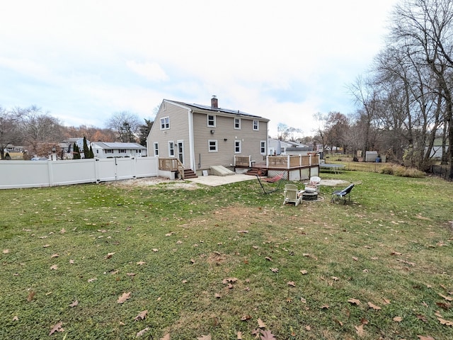 back of house with a yard and a deck