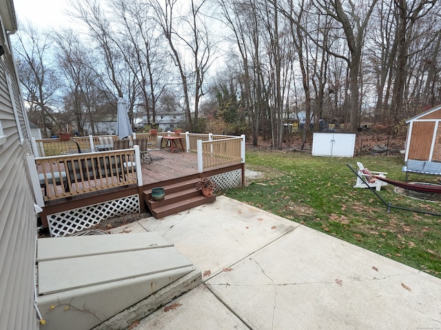 exterior space featuring a patio, a storage unit, and a lawn