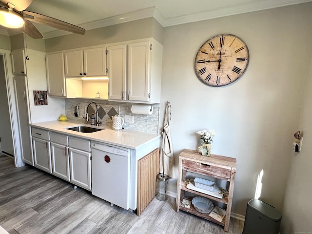 kitchen featuring a sink, dishwasher, light wood-type flooring, light countertops, and a ceiling fan